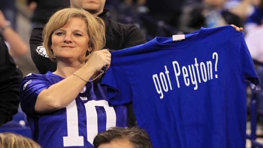 A fan holds up a t-shirt which reads 'got Peyton' in reference to quarterback Peyton Manning.