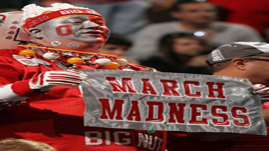 John 'Big Nut' Peters, fan of the Ohio State Buckeyes, holds up a sign which reads 'March Madness' against the Michigan State Spartans during the Final Game of the 2012 Big Ten Men's Conference Basketball Tournament.