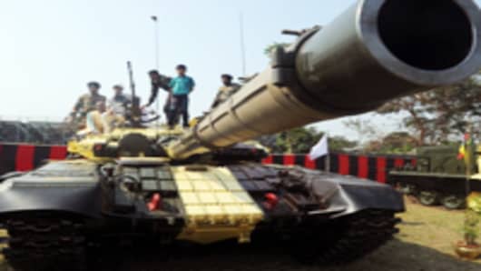 Civilian visitors sit on top of a T-72 tank during an Indian Army weaponry exhibition in Kolkata, India.