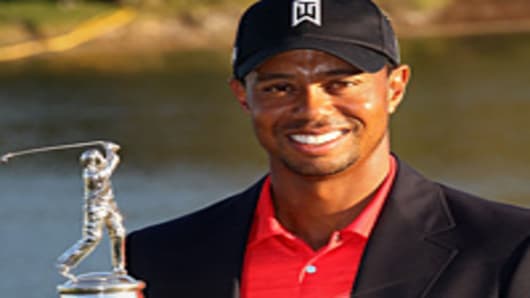 Tiger Woods holds the trophy after winning the Arnold Palmer Invitational presented by MasterCard at the Bay Hill Club and Lodge.