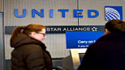 A passenger checks in at a United Continental Holdings Inc. kiosk.