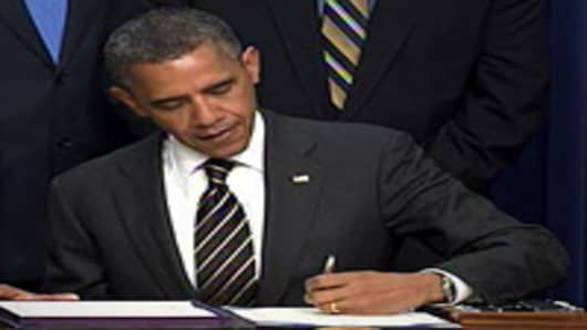 President Barack Obama signs the Stock Act.