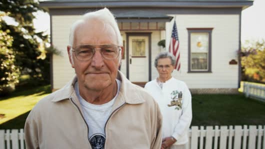 retired-couple-in-front-home-200.jpg