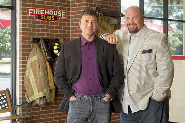 Chris and Robin Sorensen were both firefighters in Florida when they came up with the idea to open a sandwich shop based on their family’s 200 year history of fighting fires. In 1994, the brothers borrowed on a credit card belonging to Robin’s in-laws and opened their first shop, decorated with fire equipment and a hand-painted mural that depicted the local fire department. They even gave their subs firefighter-inspired names like “Hook & Ladder” and “Engine Company.” Robin worked at the store w