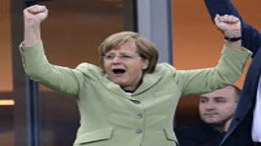 German Chancellor Angela Merkel celebrates after Philip Lahm scored against Greece during the Euro 2012 football championships quarter-final match.