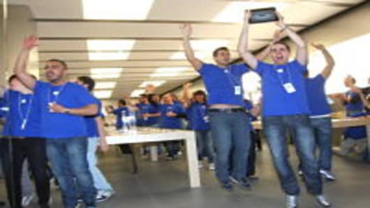 Apple Store employees cheer during the opening of the Apple Store Porta di Roma on April 21, 2012 in Rome, Italy.