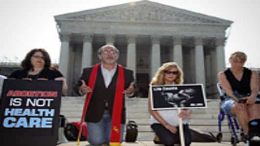 Pro-life activists, led by Rev. Pat Mahoney (2nd L) of Christian Defense Coalition, pray in front of the U.S. Supreme Court in Washington, DC.
