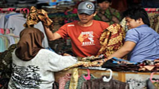 Residents shop for local goods at one of the downtown's busy sidewalk markets in Jakarta, Indonesia.