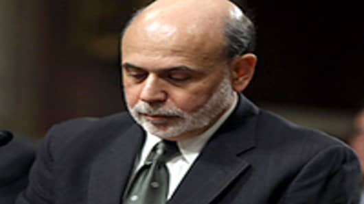Federal Reserve Board Chairman Ben Bernanke prepares to testify before the Senate Banking, Housing and Urban Affairs Committee on Capitol Hill.