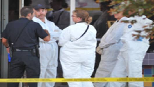 Investigators are on the scene at the Century 16 movie theatre where a gunmen attacked movie goers during an early morning screening of the new Batman movie, 'The Dark Knight Rises' July 20, 2012 in Aurora, Colorado.