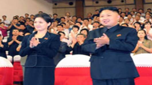 This file picture taken on July 6, 2012  shows North Korean leader Kim Jong Un, accompanied by a young woman Ri Sol-ju.