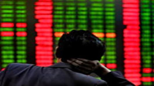 A Chinese investor monitors screens showing stock indexes at a trading house in Shanghai on June 1, 2010.