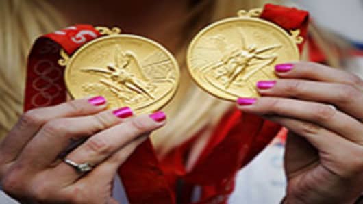 British Double Olympic Gold Medalist Rebecca Adlington shows her medals from the 2008 Summer Olympics held in Beijing, China.