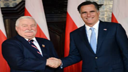 Republican presidential candidate and former Governor of Massachusetts Mitt Romney (R) shakes the hand of former Polish President and Nobel Peace Prize winner Lech Walesa, during a meeting at Artus Court, in Gdansk, on 30, 2012.