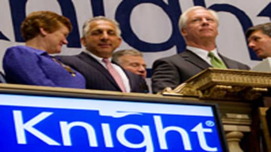 Thomas M. Joyce, chairman and chief executive officer of Knight Capital Group Inc., second from the right, waits to ring the opening bell at the New York Stock Exchange in New York, U.S., on Tuesday, May 25, 2010.