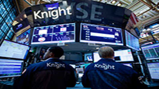 Traders work at a Knight Capital Group Inc. post on the floor of the New York Stock Exchange. Knight Capital Group Inc., struggling to stay afloat after a trading error spurred a $440 million loss.