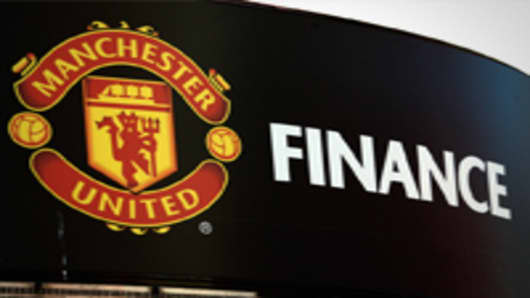 The Manchester United soccer club badge is displayed outside the Old Trafford stadium in Manchester, U.K., on Thursday, Aug. 25, 2011.