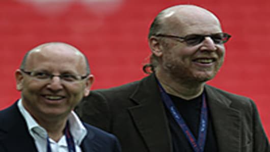 Manchester United's owners Malcom Glazer (L) and Steven Glazer attend their club's training session.