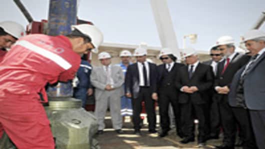 Turkey's Energy Minister (2R), Turkish Cypriot leader Dervis Eroglu (4R) and Turkish-Cypriot Prime Minister Irsen Kucuk (R), attend a ceremony an oil rig platform during a ground-breaking ceremony in the village of Sygkrasi, near Famagusta, where the state-run Turkish Petroleum Corporation (TPOA) bored their first onshore probe on April 26, 2012.Turkey began its first exploratory oil and gas drilling in the breakaway northern sector of the divided Cyprus on April 26, amid a dispute over rights t
