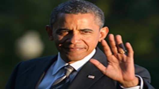US President Barack Obama waves as he walks across the South Lawn upon return to the White House.