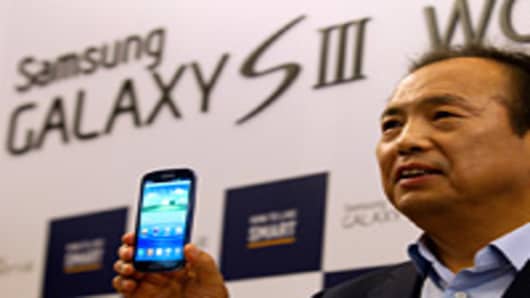 J.K. Shin, president of mobile communications for Samsung Electronics Co., presents the company's Galaxy S III smartphone at a launch event in Seoul, South Korea.
