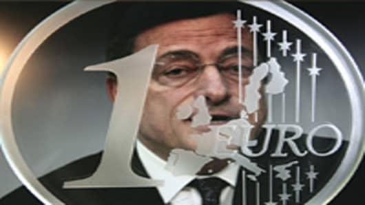 The guardian of the euro - Mario Draghi, president of the European Central Bank, ECB, behind a glass euro coin.