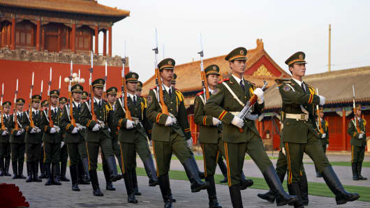 Chinese soldiers marching in front of the Forbidden City in Beijing, China.