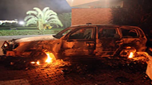 A vehicle sits smoldering in flames after being set on fire inside the US consulate compound in Benghazi late on September 11, 2012