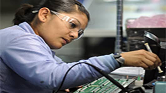 A worker solders components at the Suntron de Mexico assembly plant in Tijuana, Mexico.