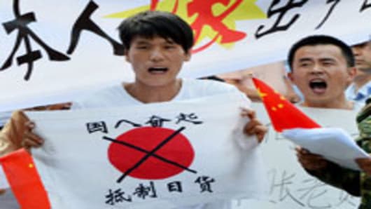 Anti-Japanese demonstrators hold banners and shout slogans as they protest over the Diaoyu Islands issue, known in Japan as the Senkaku Islands, outside the Japanese embassy in Beijing.