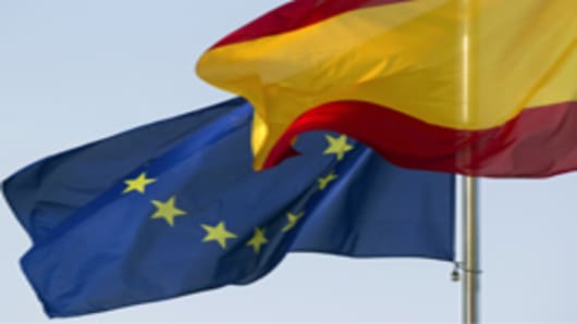 The European Union (EU) flag, left, flies alongside the Spanish national flag.
