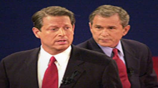 Democratic presidential candidate Vice President Al Gore talks to the audience while the Republican candidate Texas governor George W. Bush looks on October 17, 2000 in St. Louis, Missouri at the third and final presidential debate of the campaign.