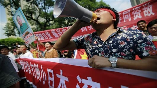 Protesters shout anti-Japan slogans near the Japanese Consulate General in Shanghai, China.