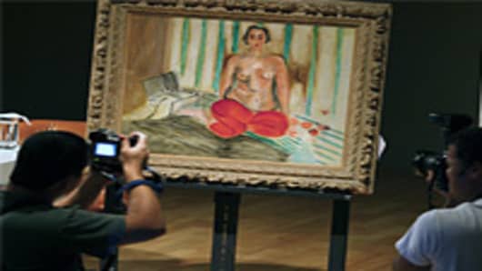Photographers take pictures of the painting 'Odalisque in Red Pants' of French painter Henri Matisse.
