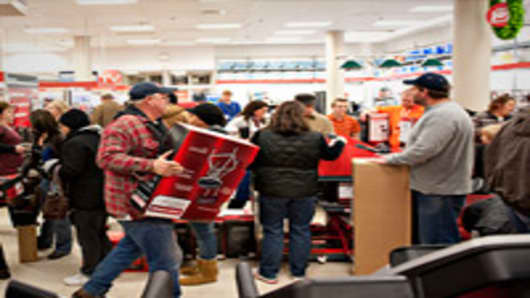 Black Friday shoppers wait to pay for items in a Sears store at Simon Property Group Inc.'s Great Lakes Mall in Mentor, Ohio.