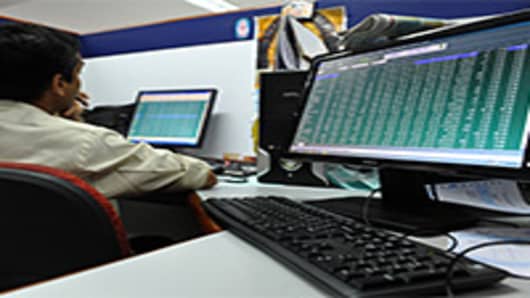 Indian stock dealers keep a watch on share prices at the Bangalore Stock Exchange.