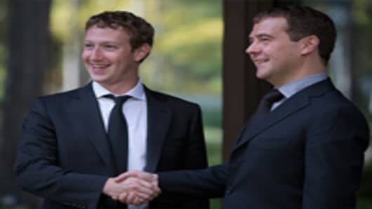 Russia's Prime Minister Dmitry Medvedev (R) and Facebook CEO Mark Zuckerberg shake hands as they meet at the Gorki residence outside Moscow, on October 1, 2012.
