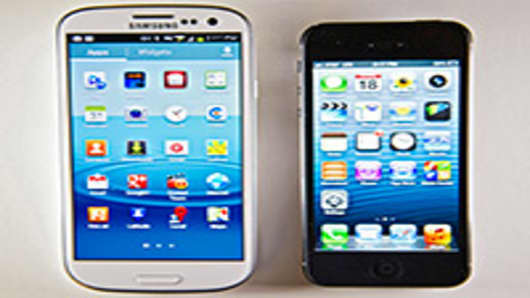 The Apple Inc. iPhone 5, right, and the Samsung Electronics Co. Galaxy S III