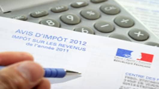 A person fills out a tax declaration for the 2012 income tax on September 10, 2012 in Lille, northern France.