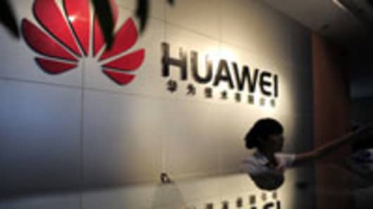A receptionist sits behind the counter at the Huawei office in Wuhan, central China's Hubei province.