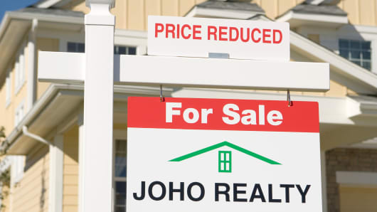 Price reduction sign on a house for sale
