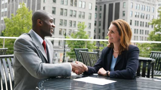 male and female shake hands at job interview