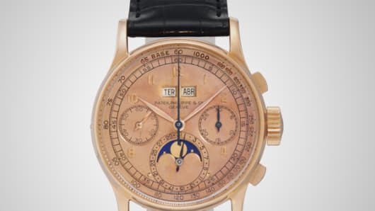 A signed Patek Philippe wrist watch with moon phases and pink dial goes up for auction at Christie's New York.