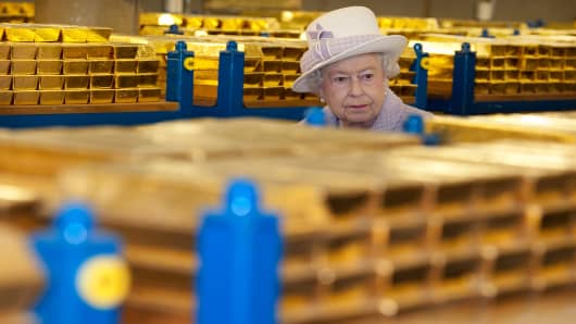 Queen Elizabeth II views stacks of gold as she visits the Bank of England with Prince Philip, Duke of Edinburgh on December 13, 2012 in London, England.