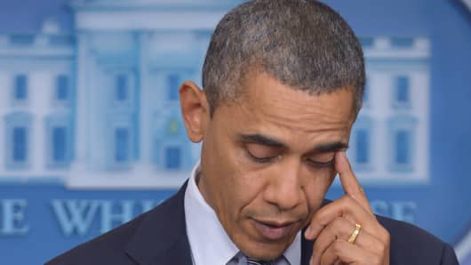 US President Barack Obama wipes away a tear as he speaks following the shooting in a Connecticut Elementary School.