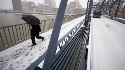 A pedestrian crosses the Smithfiled Street Bridge in Pittsburgh.