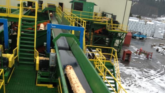 A log moves along the conveyor belt for processing in Idaho Forest Group’s Athol, Id. sawmill.