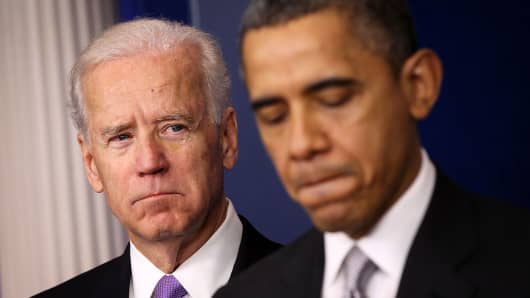 President Barack Obama speaks as Vice President Joseph Biden listens during an announcement on gun reform on December 19, 2012.