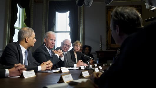 Vice President Joe Biden speaks alongside Attorney General Eric Holder (L) as he meets with representatives of victims’ groups and gun safety organizations.