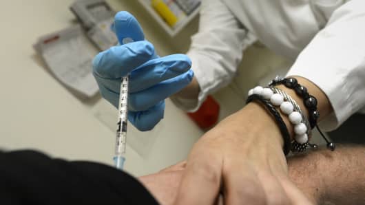 A man is given a flu shot by at the medical offices of Yaffe Ruden & Associates in New York.